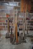 Handled tools including shovels, forks, spade, scythe