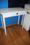 Table with drawer, pictures, frames, mirrors, shelving, wicker hamper