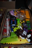 Flat with plastic toys, fire truck, school bus, water squirt toys