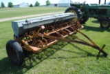 10' Minneapolis Moline grain drill with grass seeder on rubber, has a gear missing