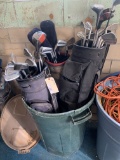 Plastic garbage can with assorted golf clubs