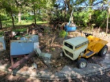 Contents of cement slab - Montgomery Ward lawn tractor (unknown if working), metal boxes, cast iron