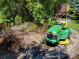 Contents of cement slab - John Deere LT150 lawn mower (unknown if working), tin, fuel barrel and sta