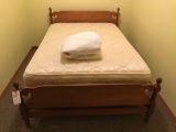 Regular-sized bed with headboard and footboard
