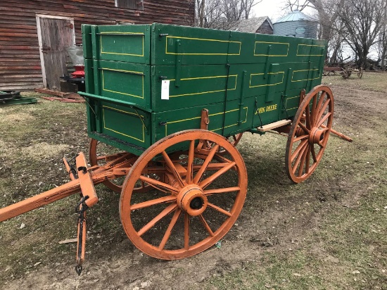 John Deere horse drawn wooden wagon. 3' x 10.5'. Wood spoke wheels (rears are 54", front are 44") In