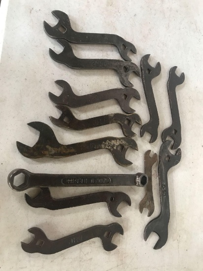 12 various numbered John Deere wrenches.