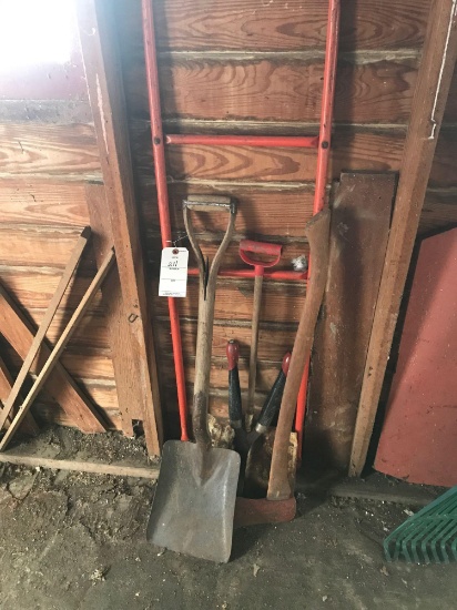 Sand shovel, axe, hedge-trimmer, and child's snow scoop.