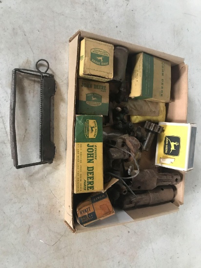 Various John Deere parts, boxes with 4 legged Deere, including bearings, and tractor parts