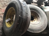 8-bolt rim and 11.00-16 tri-rib tire, and an 8-bolt John Deere 10.00-16 tri-rib tire and rim.