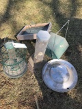 Collection of bird feeders, and a hub cap.