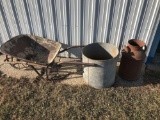 10-gallon cream can with rust at bottom, galvanized water tank, and a steel wheel wheel-barrow. No