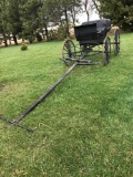 2 seated black buggy with draft horse tongue