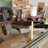 Single axle skidloader trailer, rear ramps, open mesh deck, ball hitch.