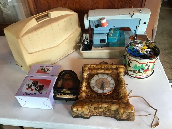 Stone framed clock, musical box, and portable sewing machine.