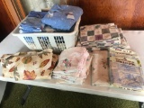 Various table cloths, flannel sheets, and decorative crocheted pillow cases.
