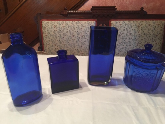 3 cobalt blue vases and one cobalt blue covered dish.