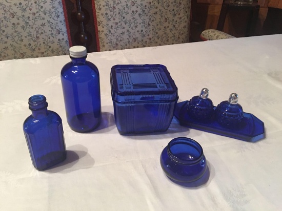 Cobalt blue salt and pepper shaker on tray, freezer jar with a lid, 2 small jars and a container.