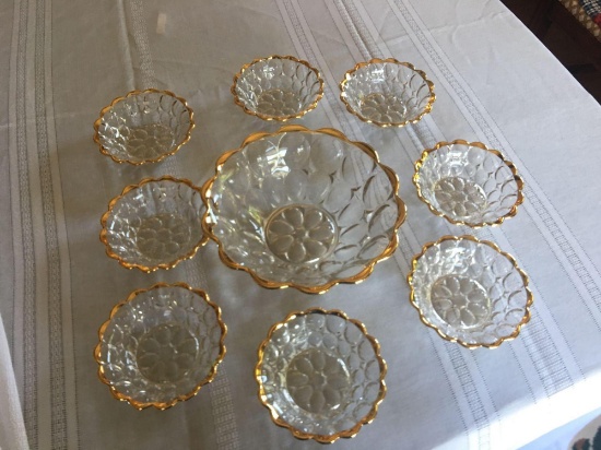 9'' diameter clear berry bowl with 8 matching smaller berry bowls all with gold trim.