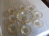 9'' diameter clear berry bowl with 8 matching smaller berry bowls all with gold trim.