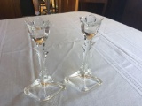 2 clear glass tulip design candle holders.