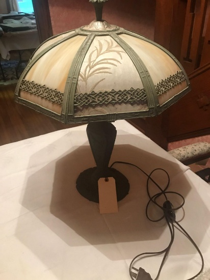 Older 24" brass table lamp with slag and fabric inserts. Two panels are missing ornamentation
