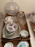 2 boxes: miscellaneous dishes, cake platter, clear glass pedestal bowl with lid, cup and saucers. No