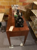 Singer sewing machine in cabinet with accessories. No shipping