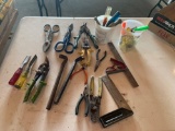 Squares, tin snips, wire stripper, small crowbars, wood chisels, and miscellaneous screwdrivers. No