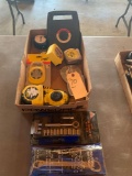 Assortment of tape measures including one of 100 feet, 1/4'' drive socket set, universal wrench set.