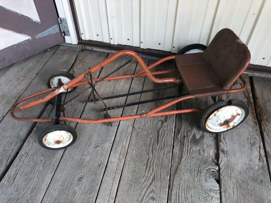 Pedal-car frame (no outside tin work), includes 4 steel wheels w/rubber, steel seat, and pedals.