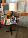 Sm. 29'' round cafe table, table lamp, book rack, several books, tin, picture frames, and more.