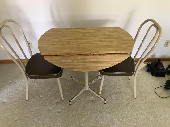 22" X 36" drop leaf kitchen table with two padded chairs. NO SHIPPING!
