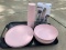 A set of 4 plastic pink plates, bowls, & cups
