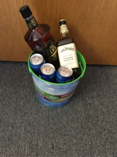 A bucket with Jack Daniels Tennessee Honey Whiskey, 8 Bud Lights, & a bottle of Black Velvet (Fran &
