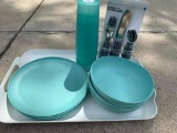 A set of 4 plastic turquoise plates, bowls, & cups