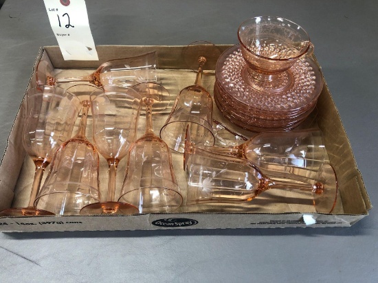 Eight pink Depression glass water glasses, eight plates, one small platter and one cup.