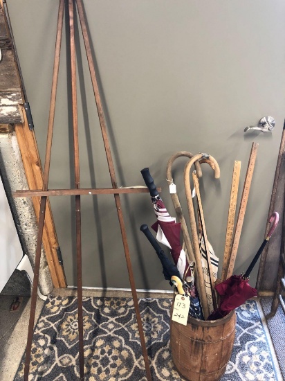 Wooden nail keg with 6 old umbrellas, 2 canes, 3 yard sticks. NO SHIPPING.