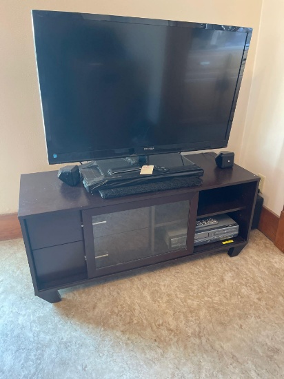 Toshiba 42'' flat screen TV on stand and with Magnavox DVD and VHS player.