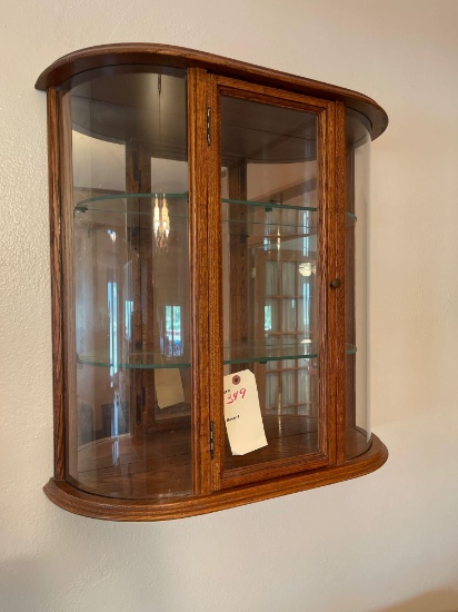 Oak wall mounted curved glass display cabinet.