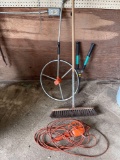Measuring wheel, broom, trouble light, two handled trimmer.