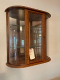 Oak wall mounted curved glass display cabinet.