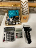 Office supplies including calculators, staplers, paper clips and file storage