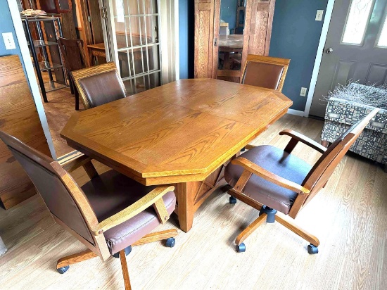 Really nice oak dining room table,60'' x 42'', 1 leaf, 4 leather chairs on casters. Nice set!!! ...