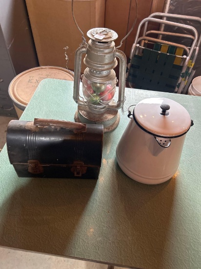 Metal lunch pail, white enamel coffee pot, kerosene lantern