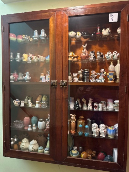 Large glass displey cabinet of various salt and pepper shaker sets.......