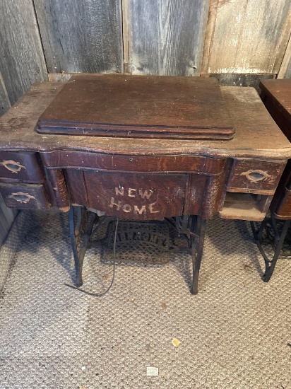 New Home treadle sewing machine in cabinet.