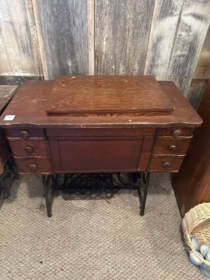 Franklin treadle sewing machine in cabinet.