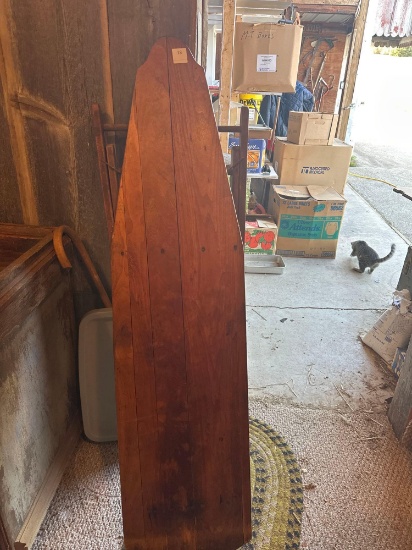 Wooden ironing board and cream can with lid.