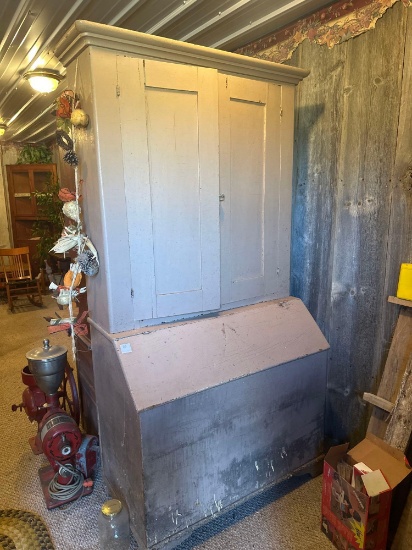 Vintage painted kitchen cabinet with bottom storage.