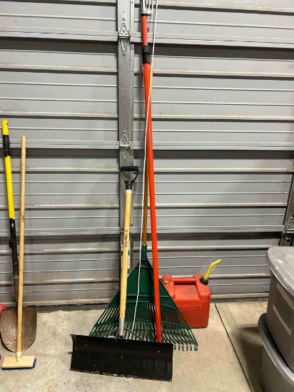 Snow shovel, plastic rake, gas can, tree pruner